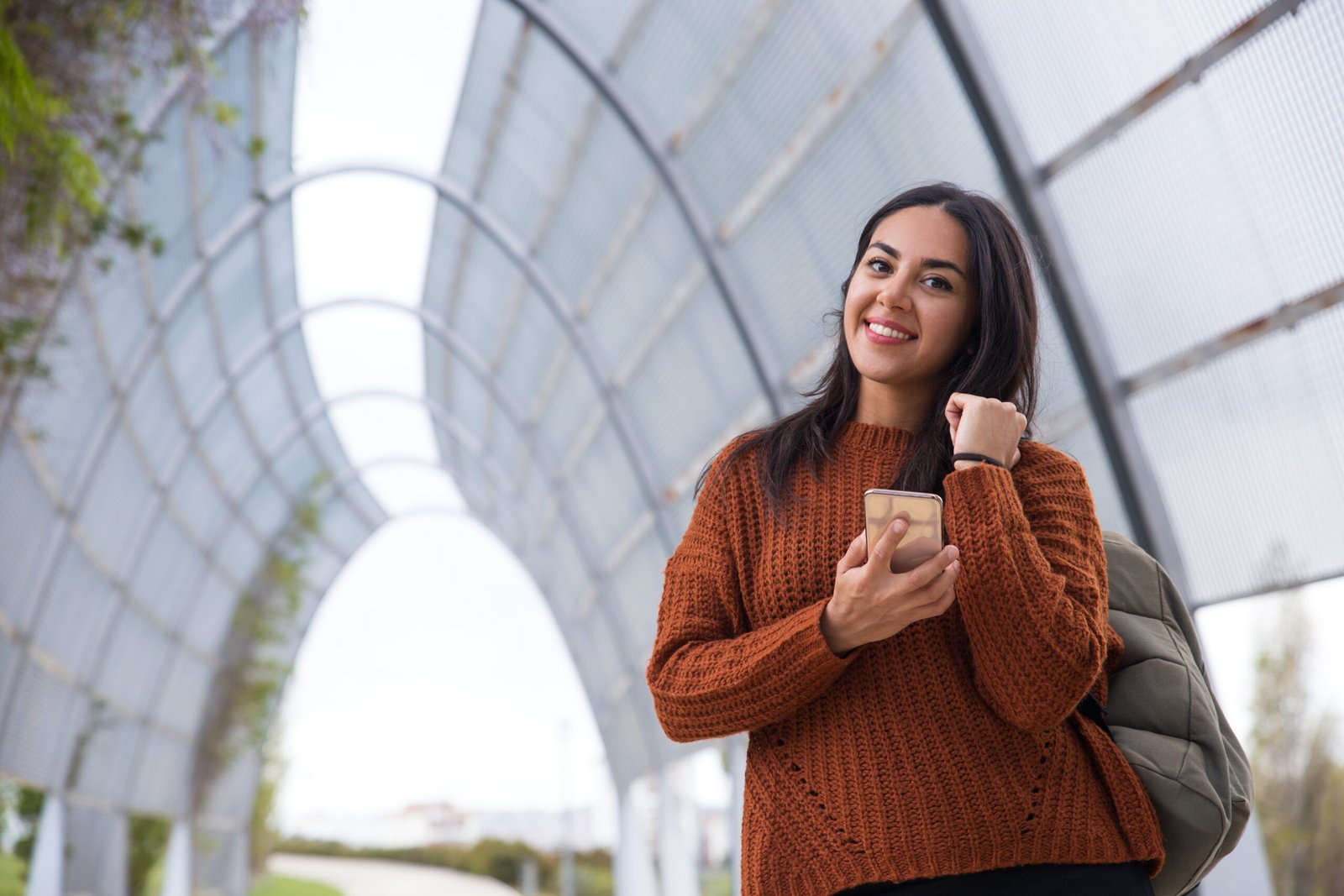 cheerful attractive young woman with black hair walking